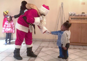 children greet with Santa Claus