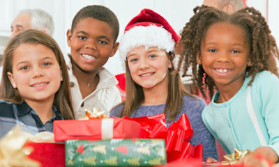 Children come to collect their gifts during the delivery of gifts to 100  vulnerable children of the Cañada Real, January 4, 2023, in Madrid (Spain).  Fundación Madrina is distributing gifts until tomorrow